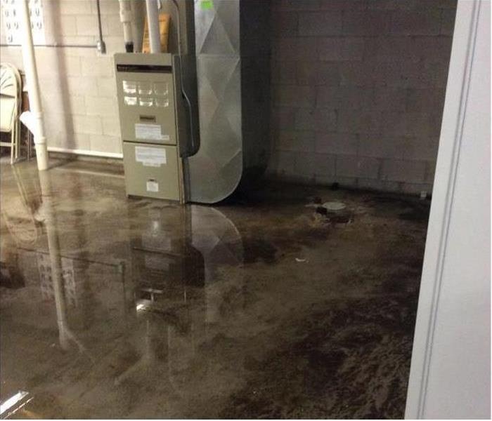 Commercial building concrete floor flooded with water 